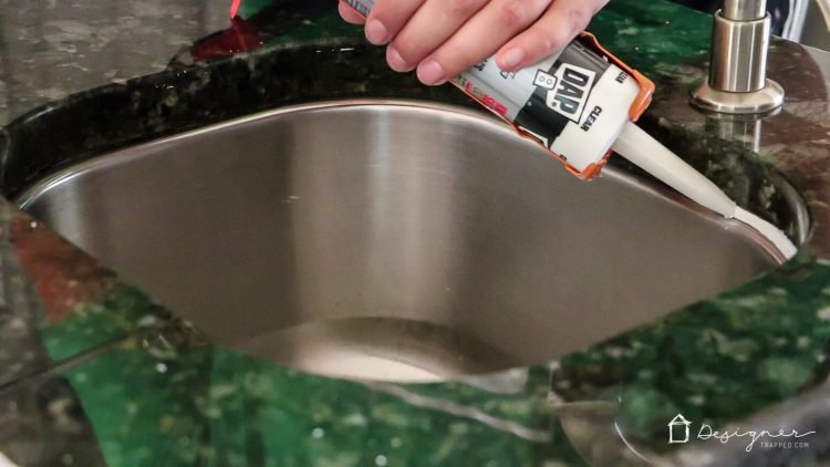 replace dirty caulk around kitchen sink